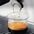 Espresso dripping from bottomless portafilter directly into Culturbo single spout shot glass.
