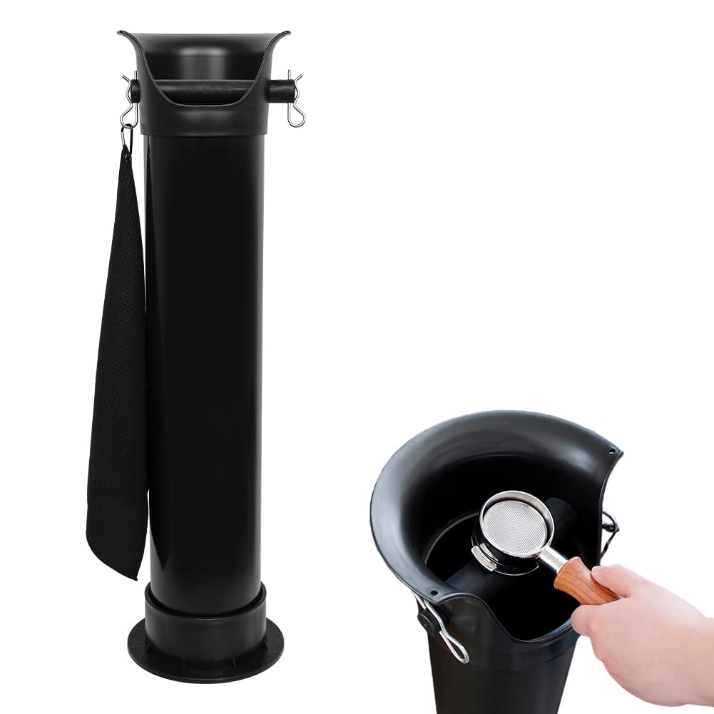 Barista holding an espresso portafilter and tapping it down onto the floor standing dump bin to discharge coffee pucks.
