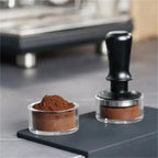 Practicing espresso tamping with clear puck preparation cup