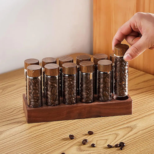14-piece single dose coffee bean storage tubes with solid walnut wood stand.