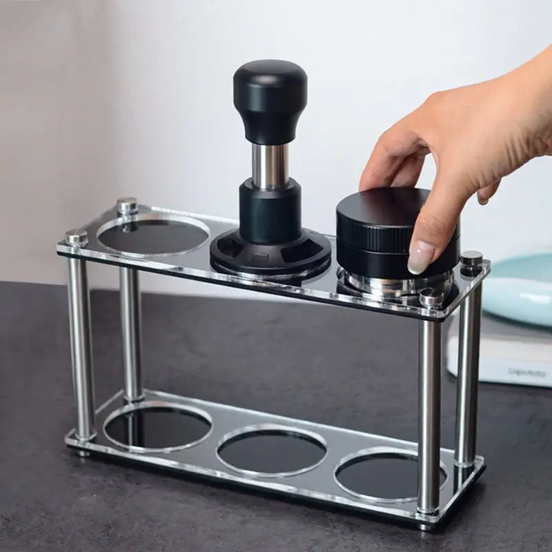 Home barista placing an espresso distributor on a double-tier acrylic tool stand