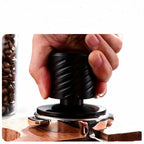 Barista using spring loaded constant pressure espresso tamper in portafilter.