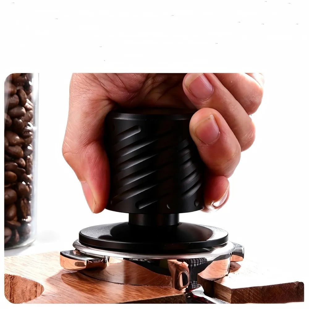 Barista using spring loaded constant pressure espresso tamper in portafilter.