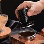Precision fit espresso distributor and tamper leveling coffee grounds.