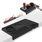 Black silicone espresso tamping mat with corner edge and natural wood cleaning brush.