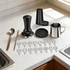 Complete set of espresso making accessories displayed on kitchen countertop.