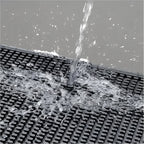 Waterproof silicone coffee mat being washed under running water, easy to clean.