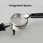 Detailed view of the espresso brush handle tail featuring a built-in measuring spoon scooping white espresso machine cleaning powder.