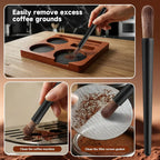 Soft cleaning brush removing excess coffee grounds from portafilter and puck screen.