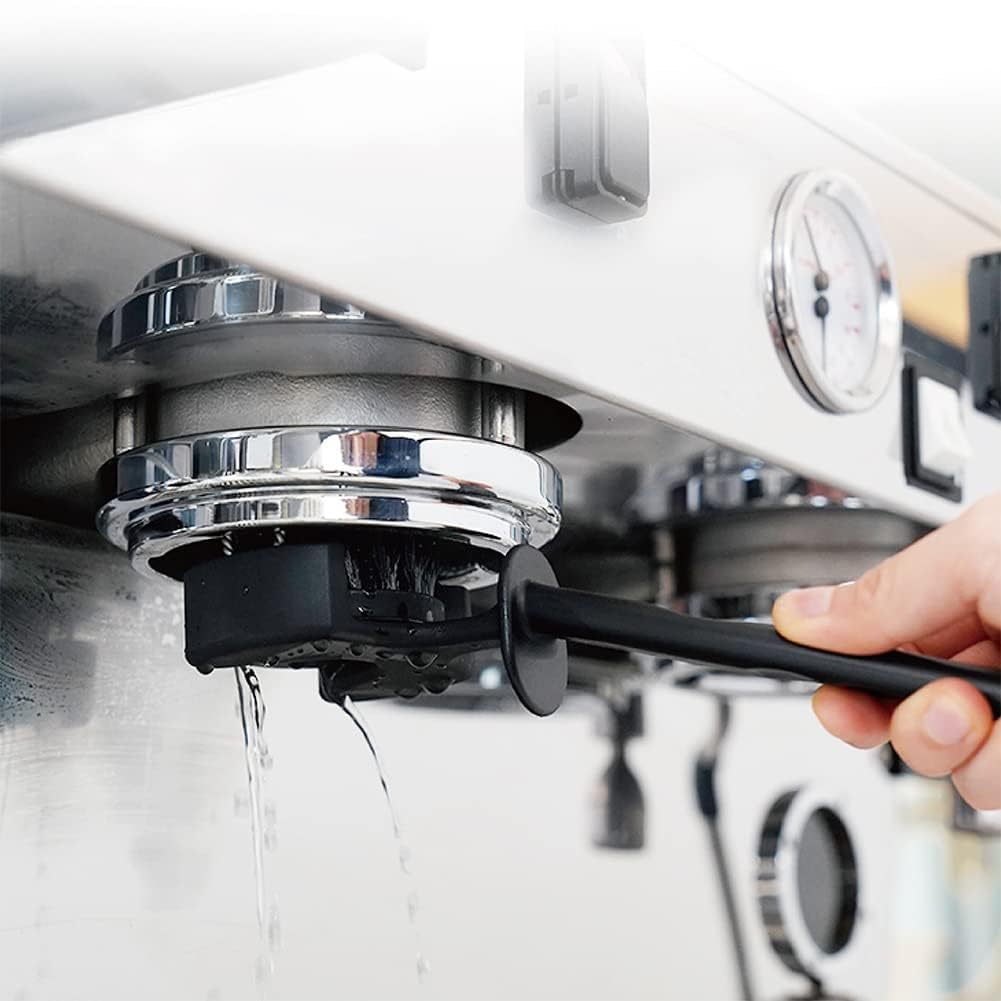 Close up shot of the 360 degree circular coffee cleaning tool fitting perfectly into a 58mm commercial espresso machine group head.