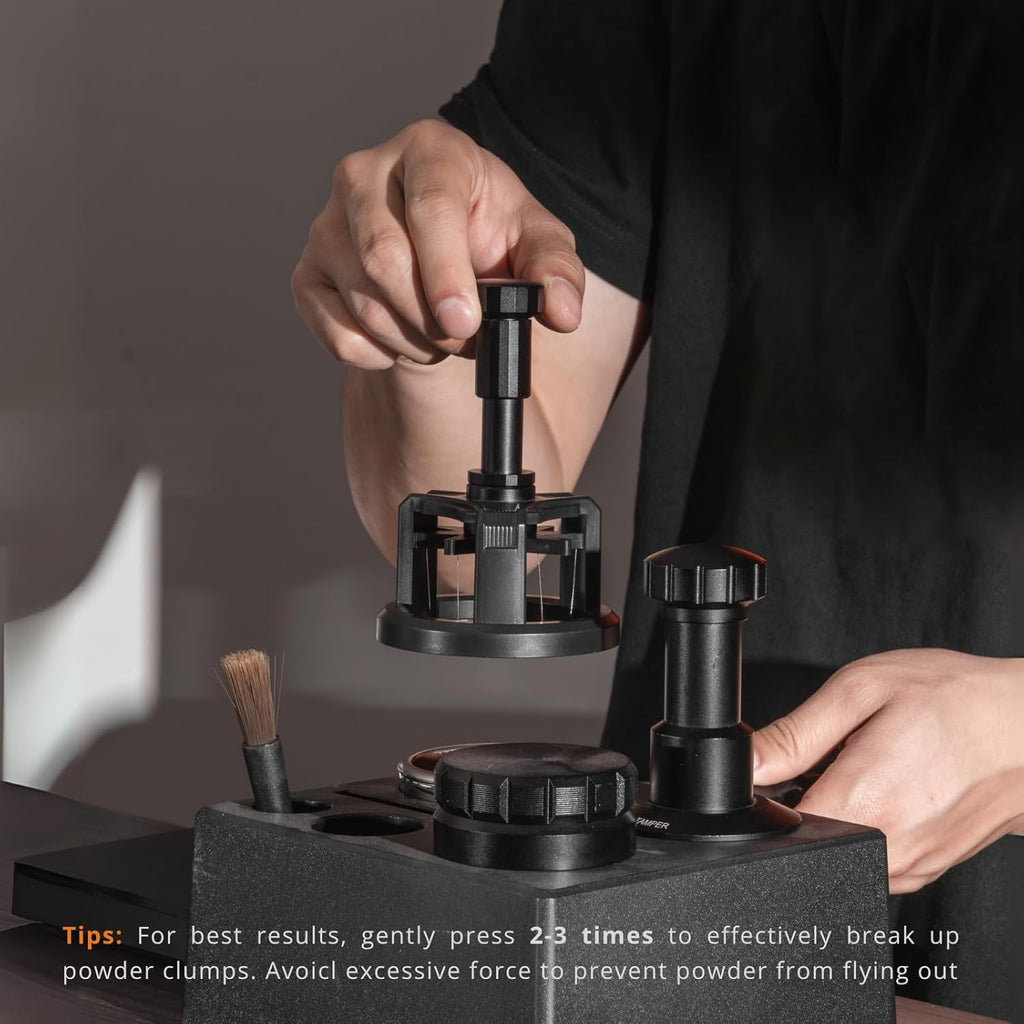Barista pressing spin WDT tool on coffee portafilter with magnetic base on espresso station.