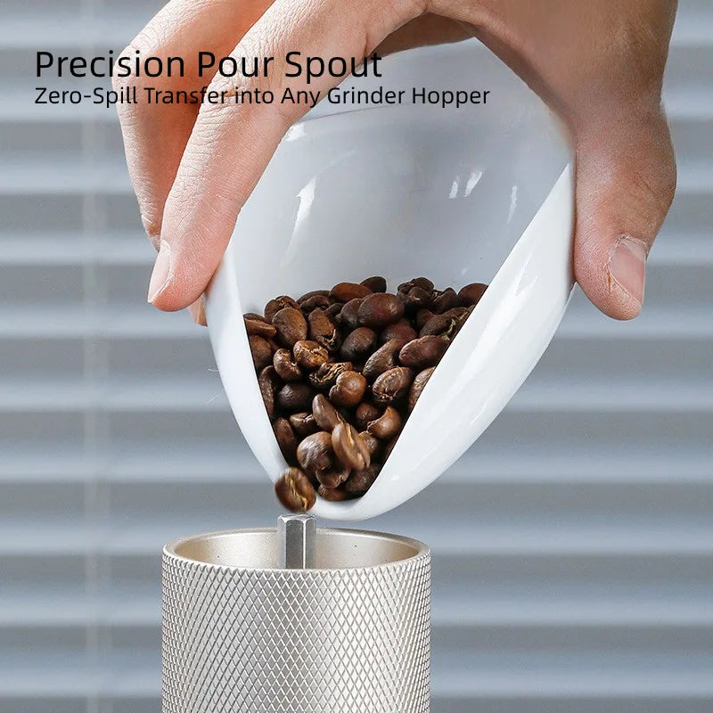 Close up of the precision pointed pour spout on the white ceramic espresso weighing bowl.