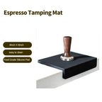 Professional L-shaped silicone espresso tamping mat on coffee station counter with premium wood tamper.