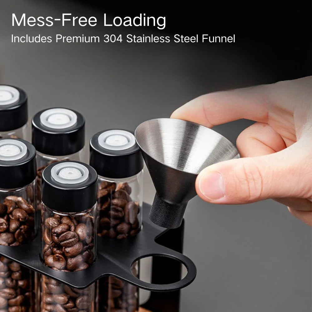 Pouring roasted coffee beans through a stainless steel funnel into the tubes.
