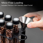 Pouring roasted coffee beans through a stainless steel funnel into the tubes.