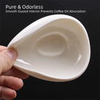 High-gloss white ceramic single-dose coffee weighing bowl with specialty coffee beans.