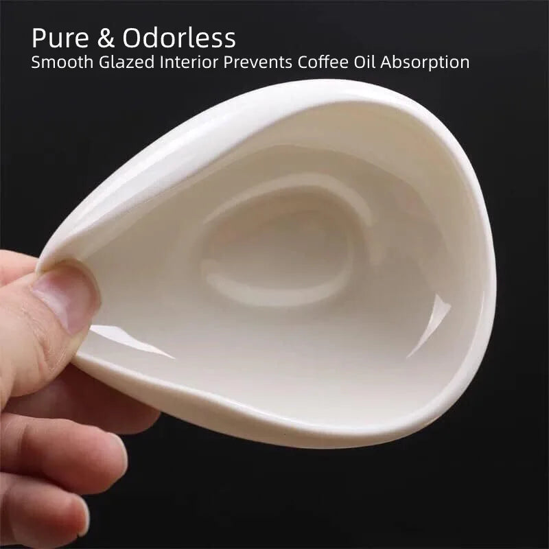 High-gloss white ceramic single-dose coffee weighing bowl with specialty coffee beans.